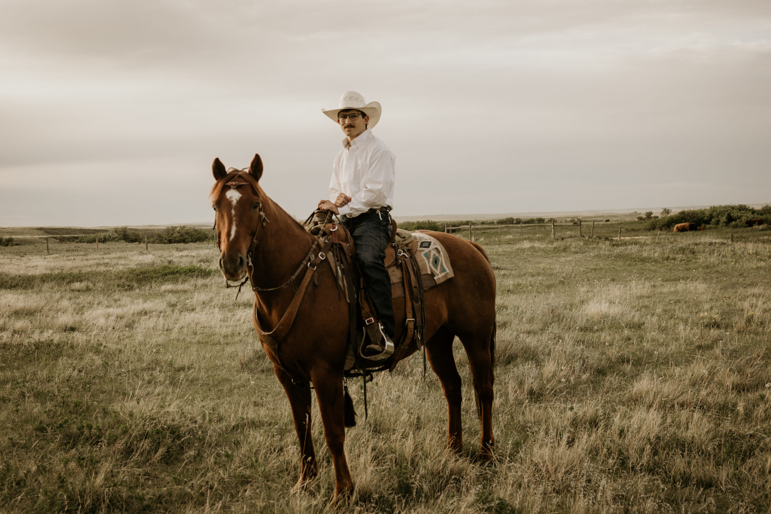 Young man on a horse during highschool graduation photos