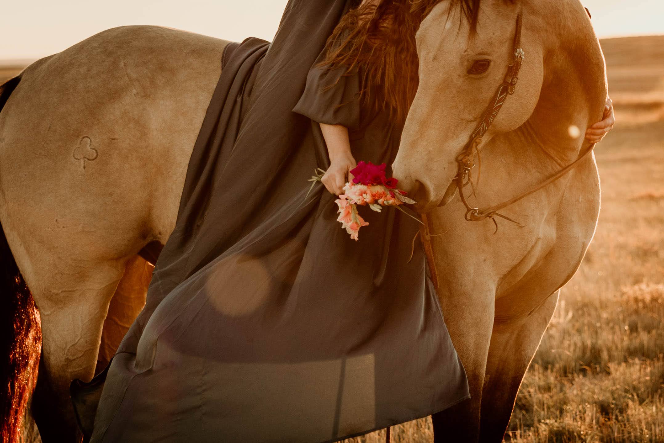 close up photo of woman with flowers in a dress on a horse in southern Saskatchewan