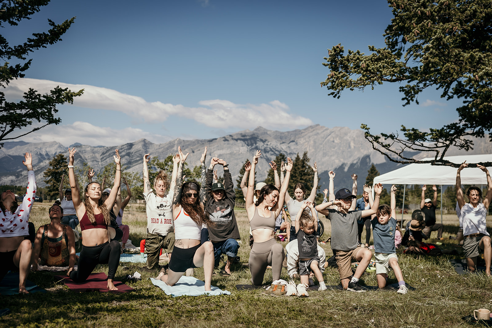community practicing yoga together while brand photographer captures the closing ceremonies at Lucent festival