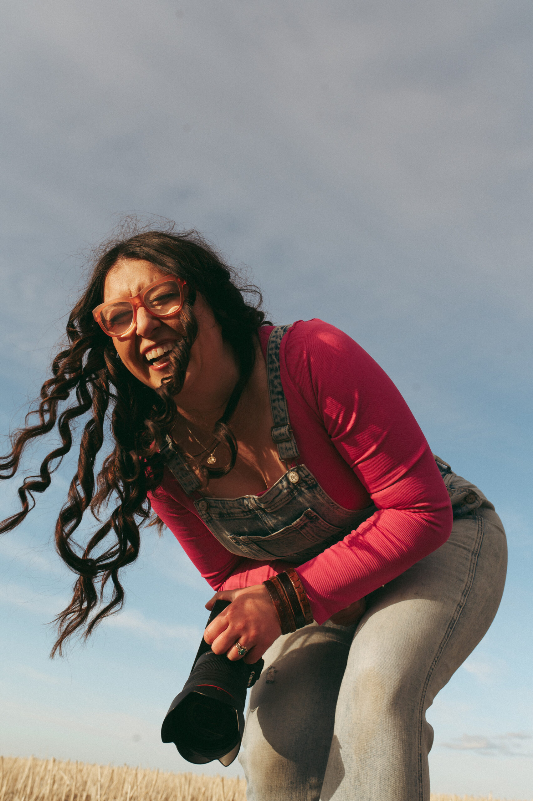 farmer and business owner laughing with camera in hand
