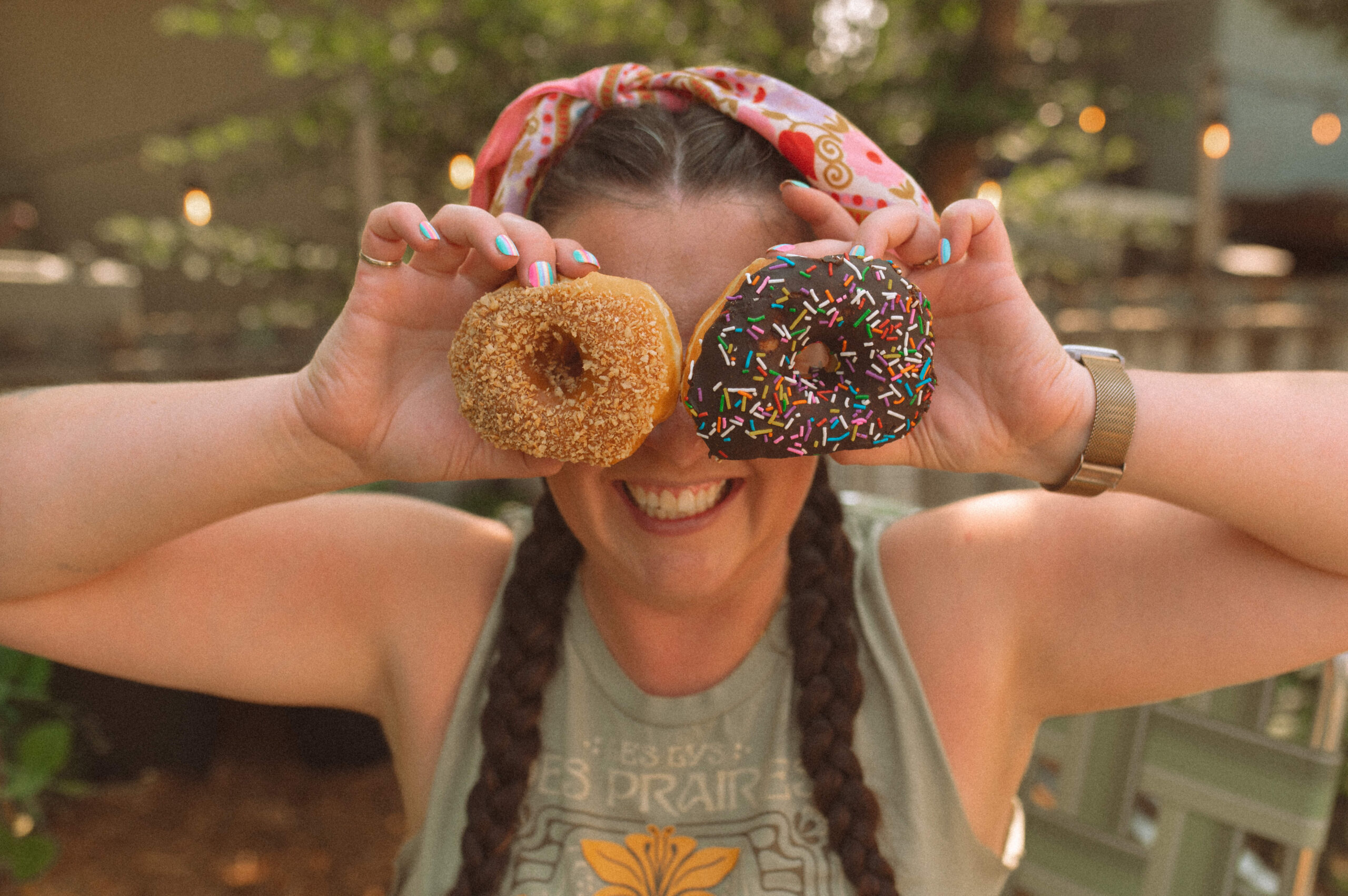 Brand photographer holds donuts to her face during photoshoot
